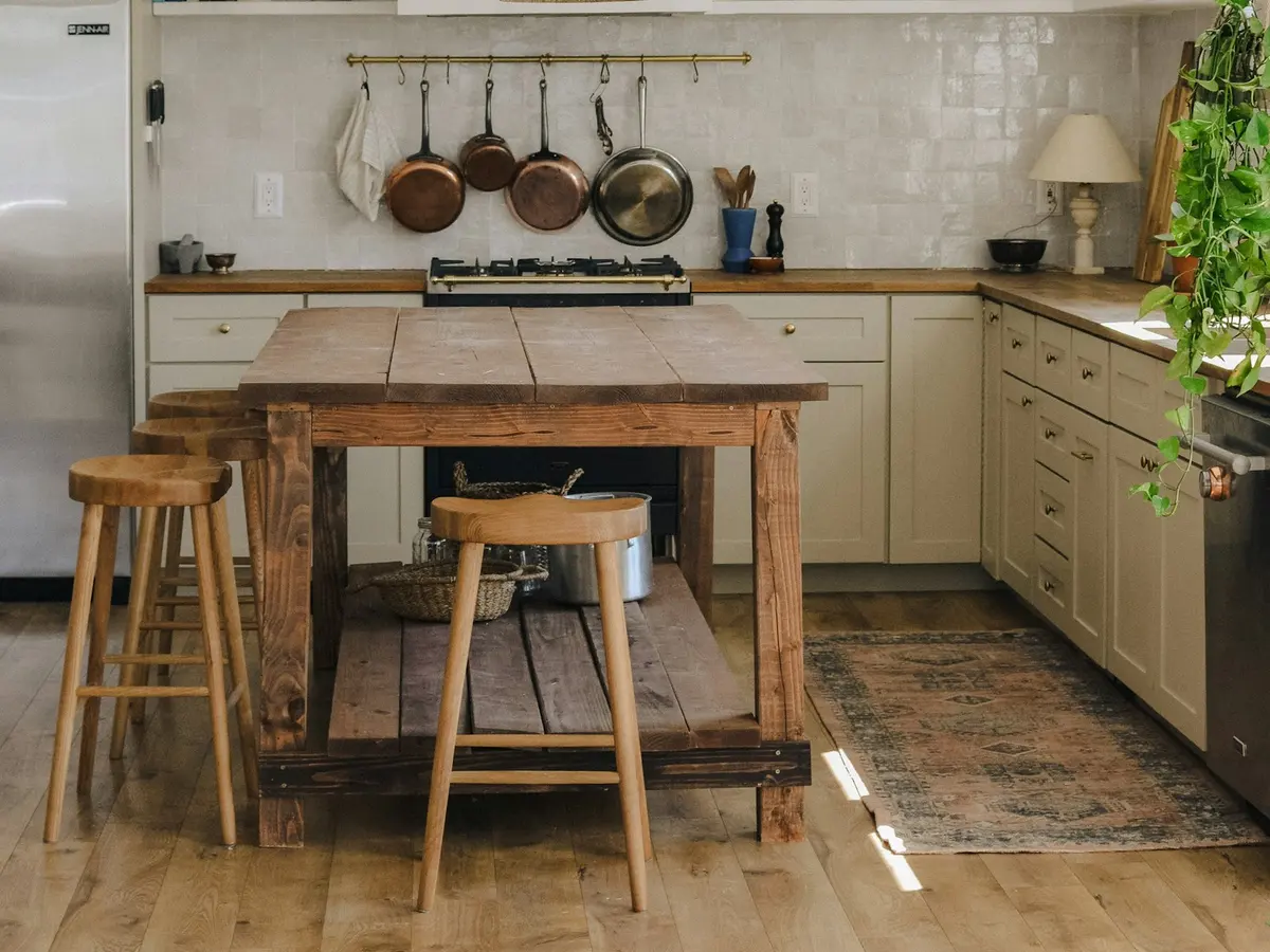 A finished butcher-block kitchen island with stools